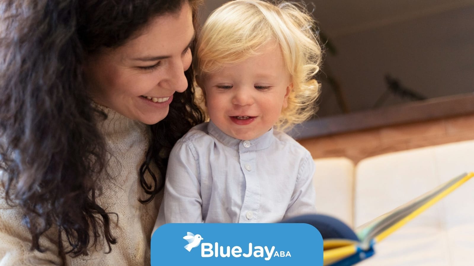 BCBA reading a book with a young child during in-home ABA.