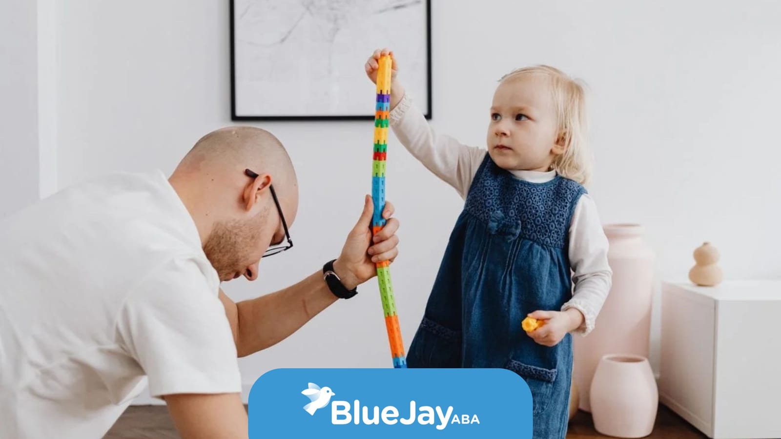 BCBA engaging a young child in play-based ABA therapy.