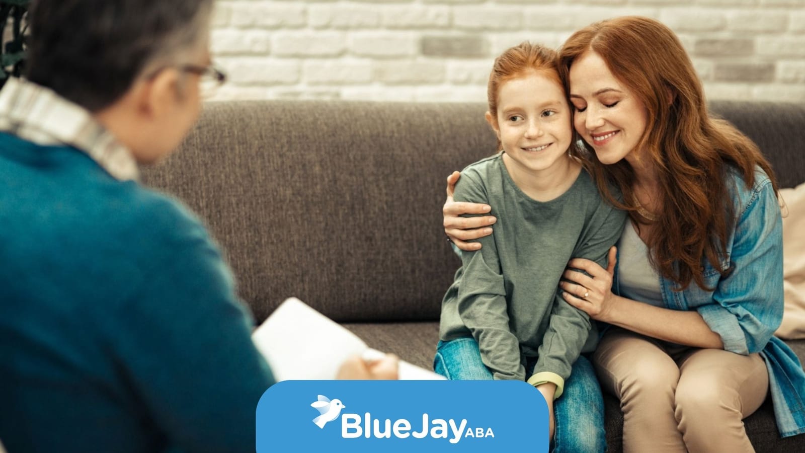 Mother and child meeting with a therapist during an ABA therapy consultation.