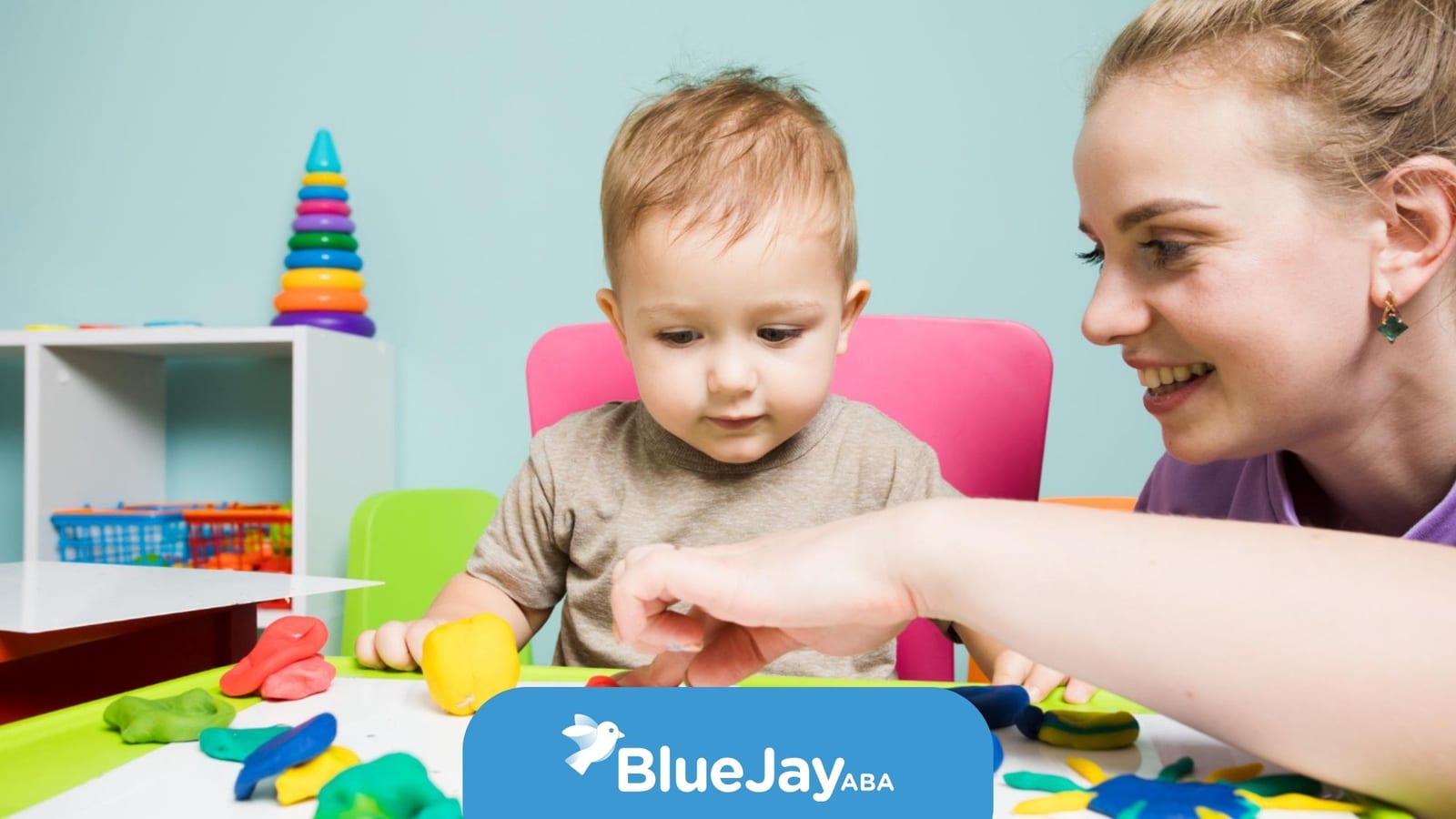 ABA therapist supporting a toddler with autism during play.
