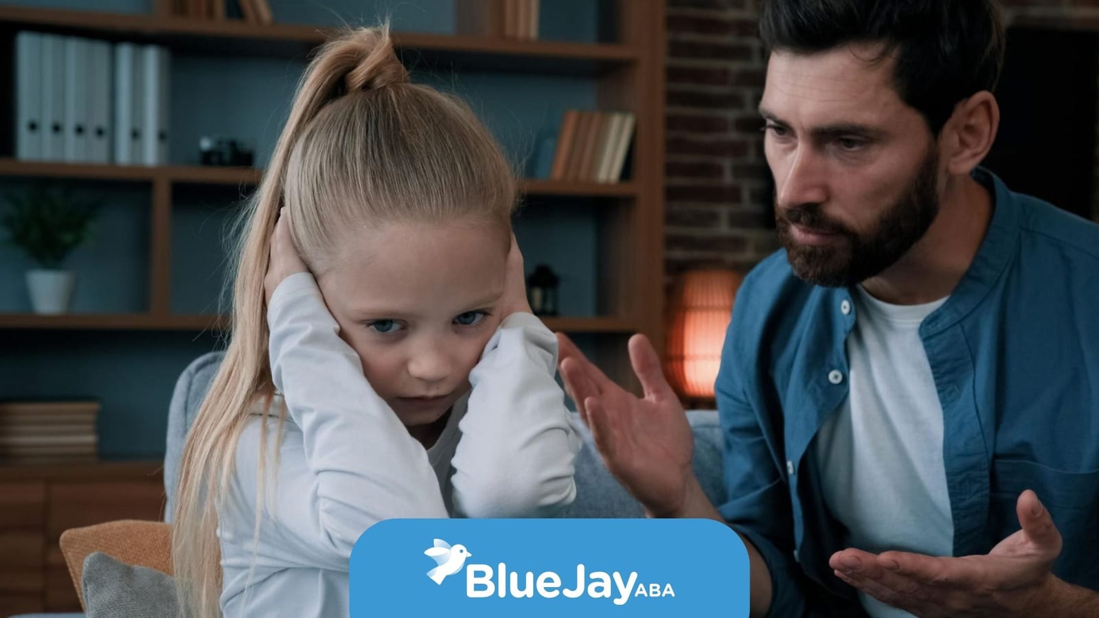 Child with autism covering her ears while a parent talks with her during an ABA therapy-related moment at home.