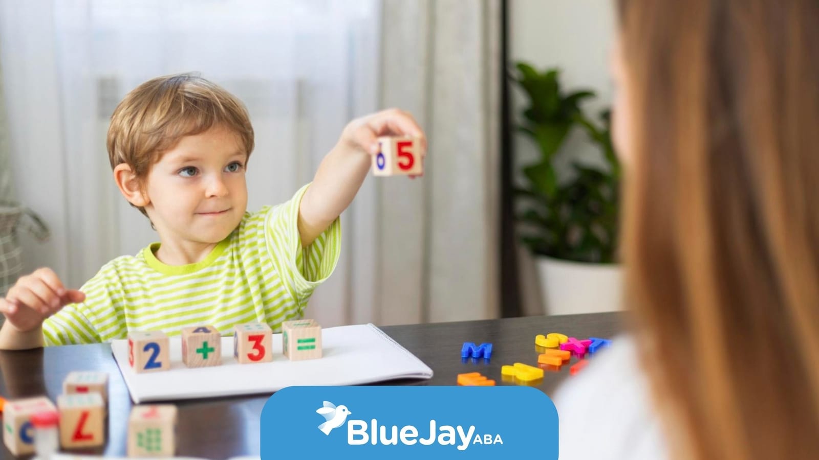 Child practicing numbers with a therapist during an ABA learning activity.