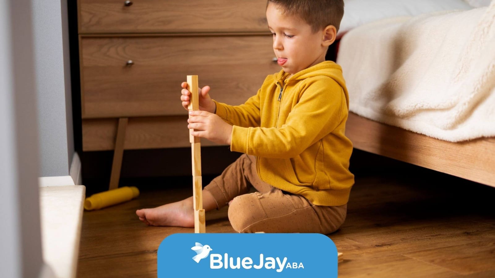 Autistic child playing independently with wooden blocks in a bedroom.