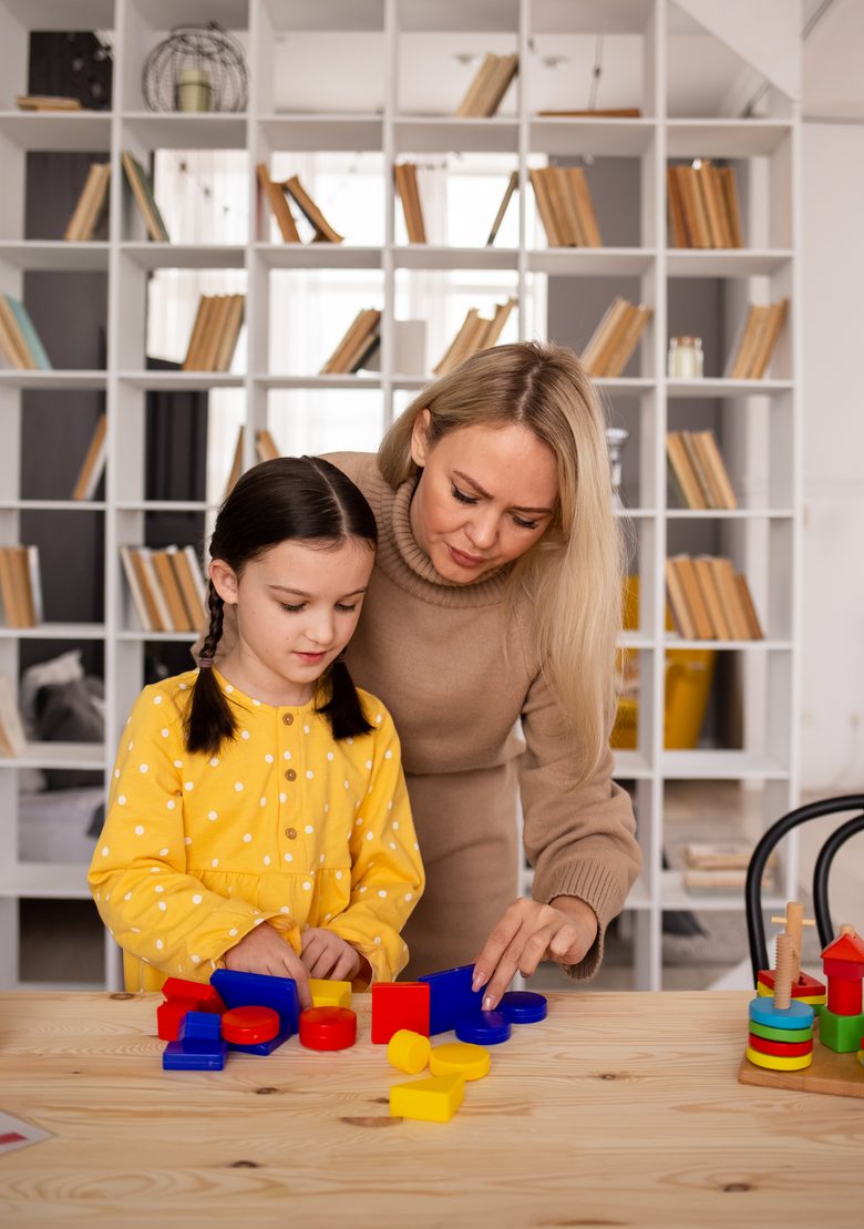 A parent guiding a child through a hands-on sorting activity