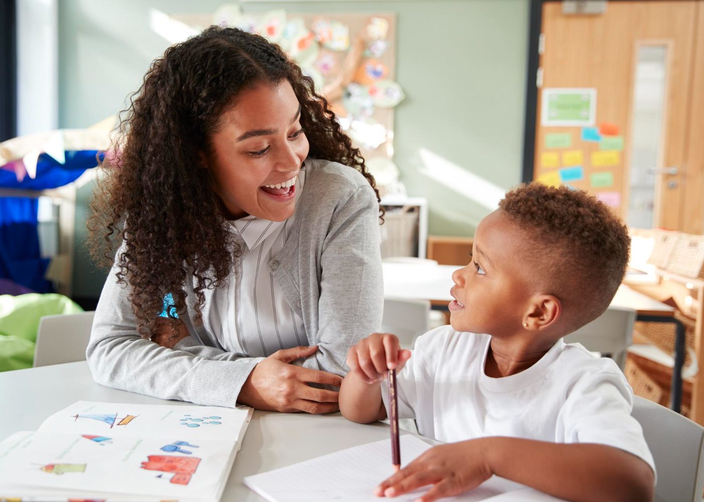 A therapist working one-on-one with a child at a table